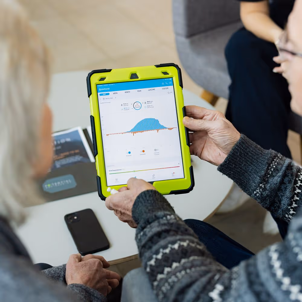 Couple looking at Enphase Enlighten app
