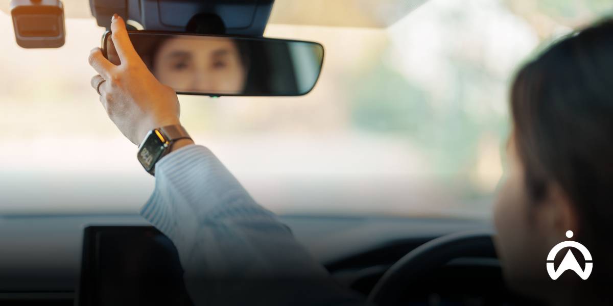 คนกำลังปรับมุมมองกระจกหน้ารถที่มีการติดกล้องหน้ารถ