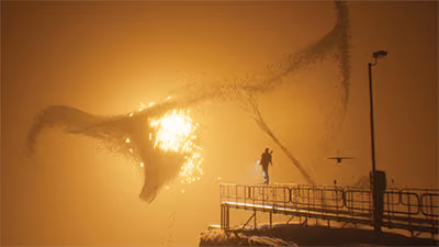 A humanoid figure stands at the end of a platform and looks at a sandy abstract shape forming in front of a yellow orange glowing light.
