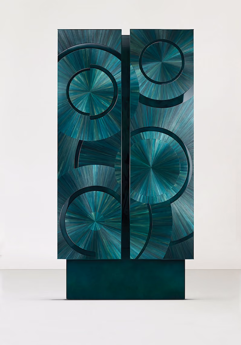 Tall emerald green wardrobe embossed with circle pattern.