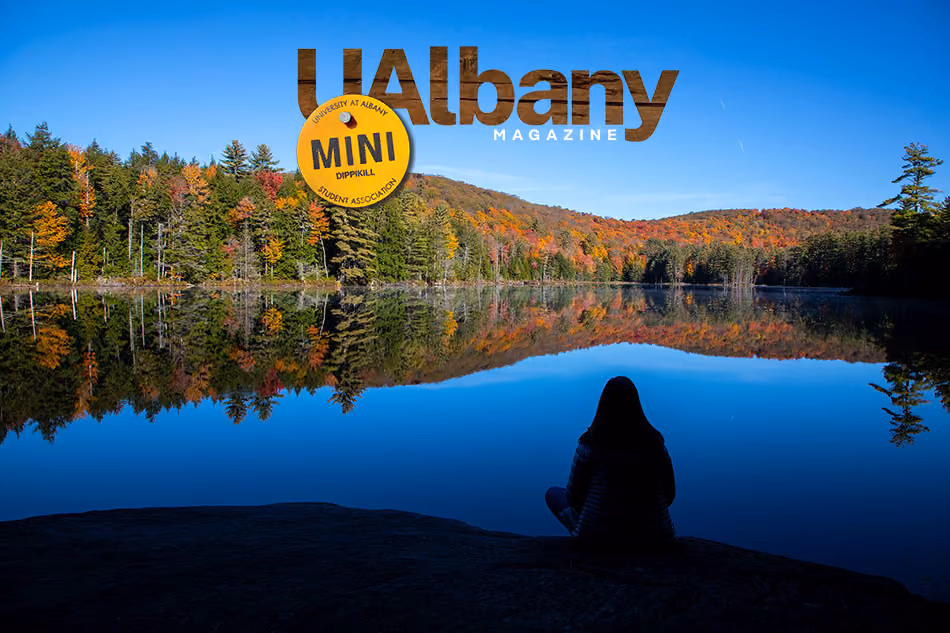 A person sits on the edge of Dippikill Pond.
