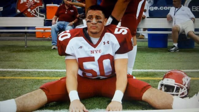 A photo from 2010 of a Nick Fiorito sitting on the sidelines dressed in his All City high school football uniform.