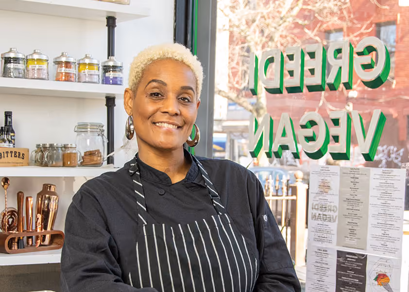 Latisha stands near the counter at the front of her restaurant Greedi Vegan.
