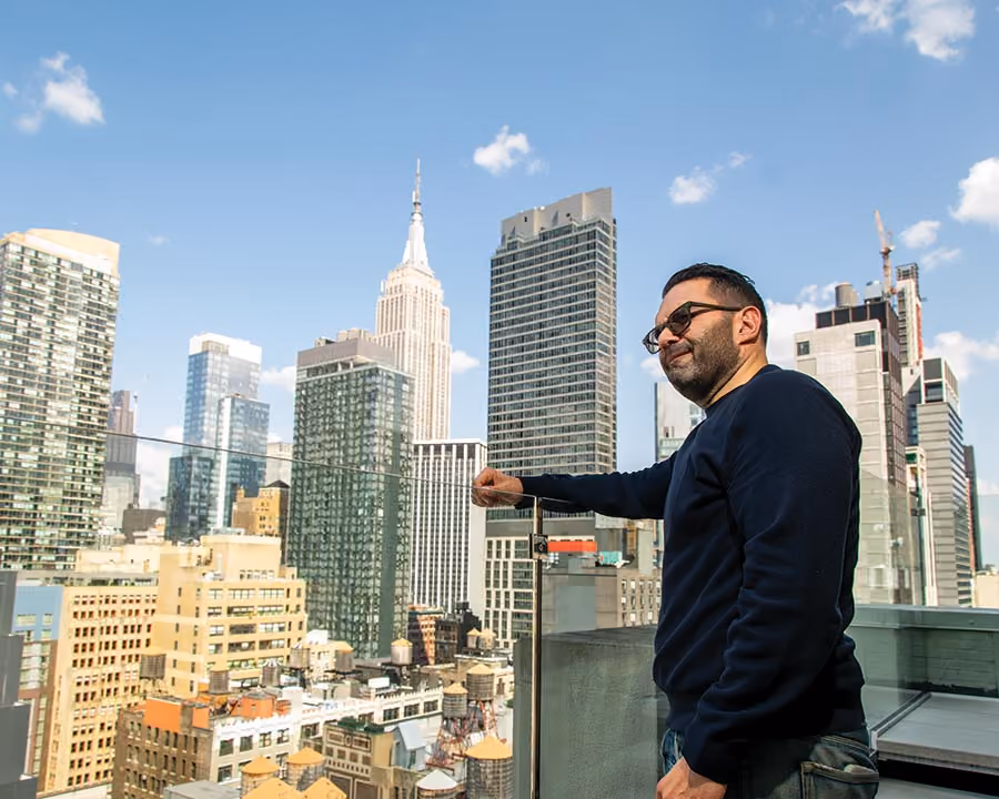 Longert looks out at a Manhattan skyline.