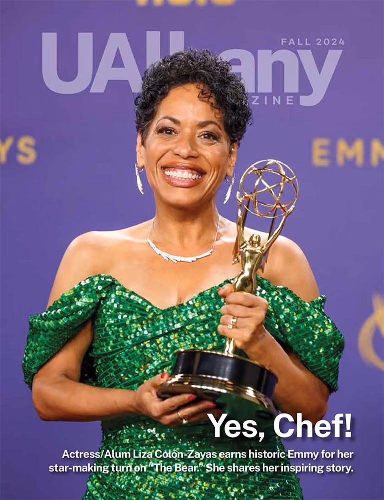 Liza Colon-Zayas on the cover of the Fall 2024 issue of UAlbany magazine after accepting her Emmy Award.