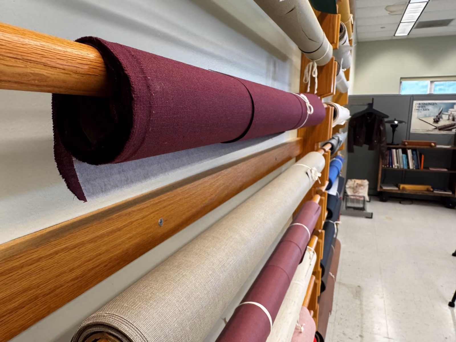 colorful rolls of fabric attached to a wall