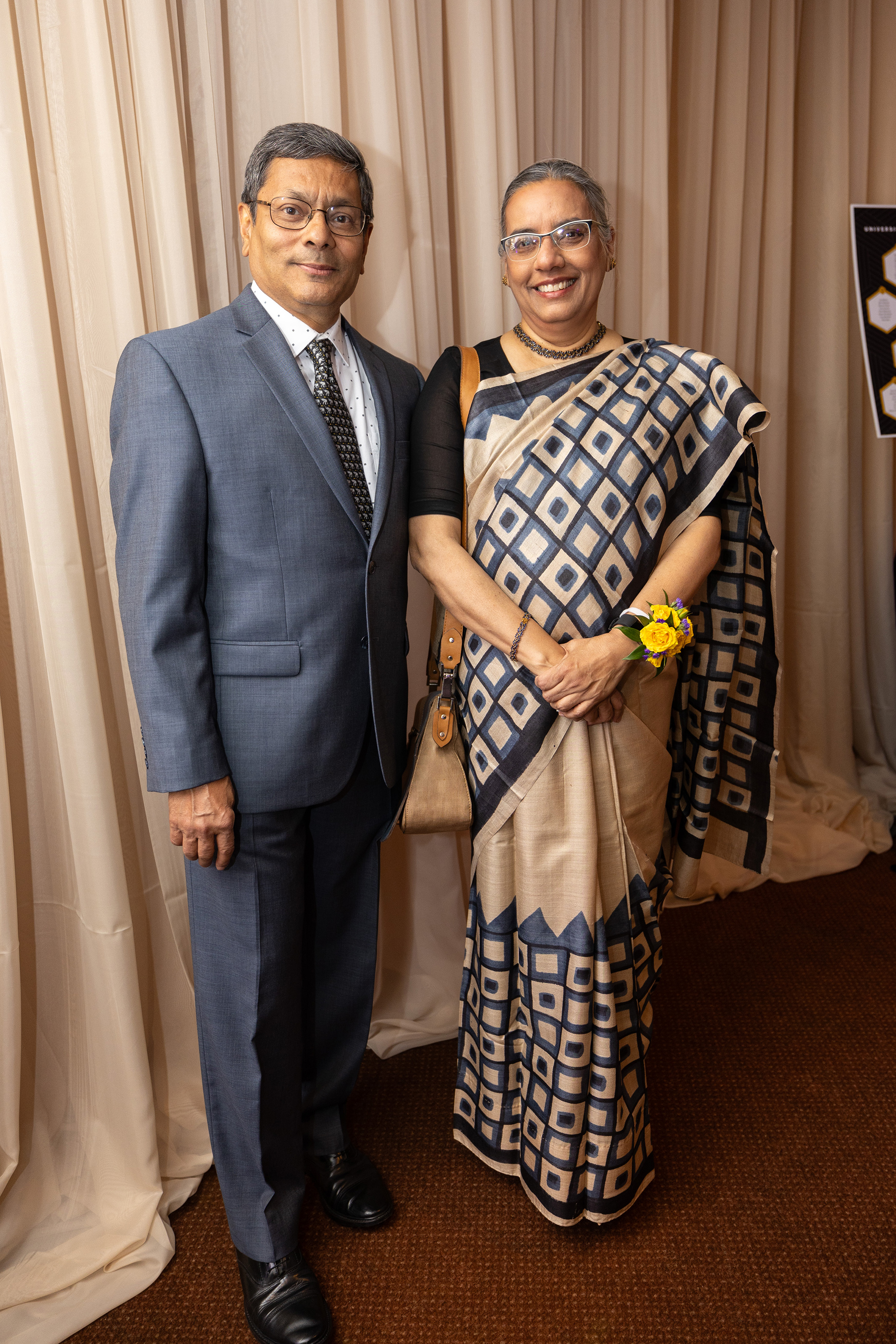Two people post at a formal event.