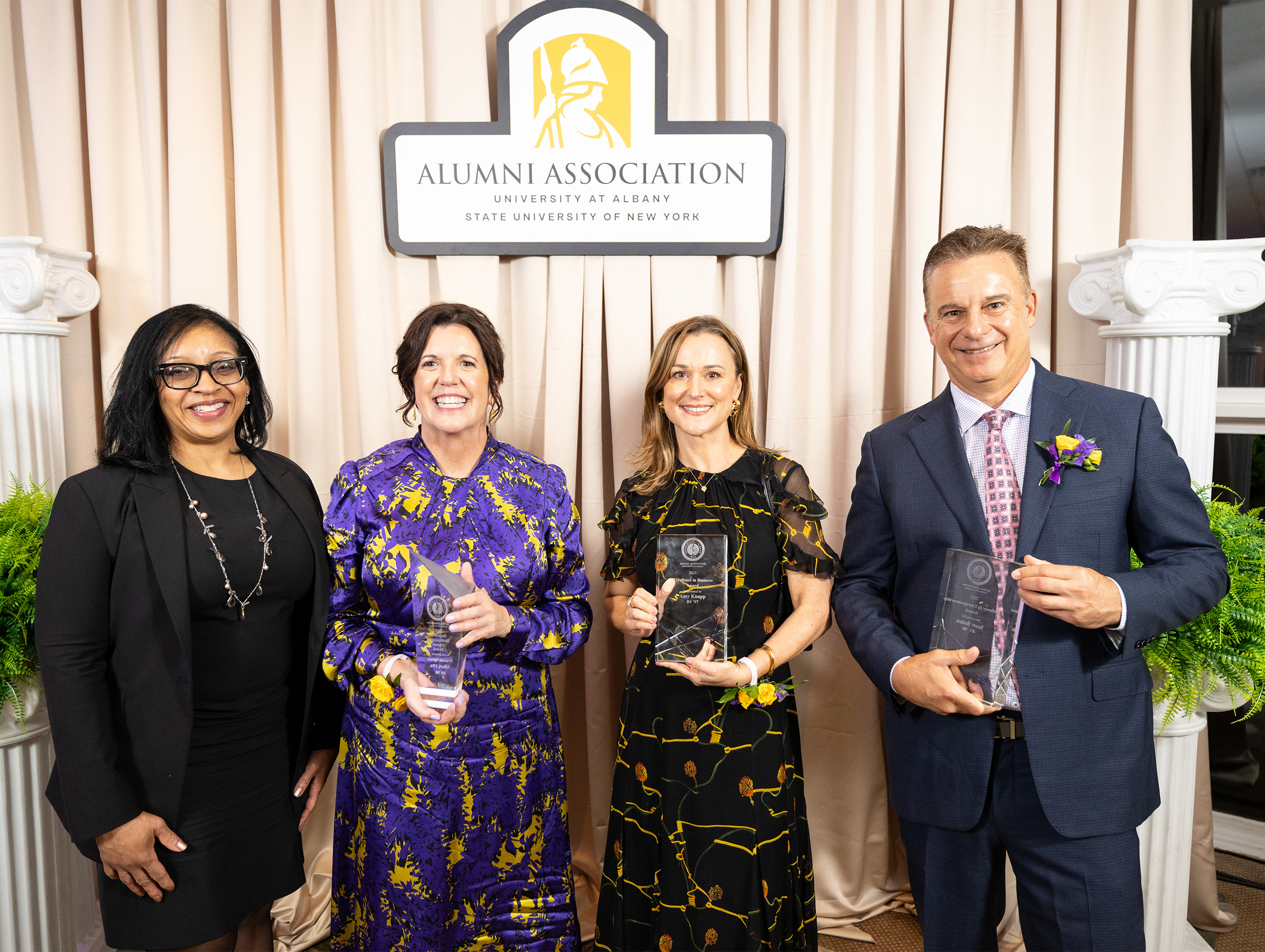 UAlbany Massry School of Business dean and alumni at an awards ceremony.