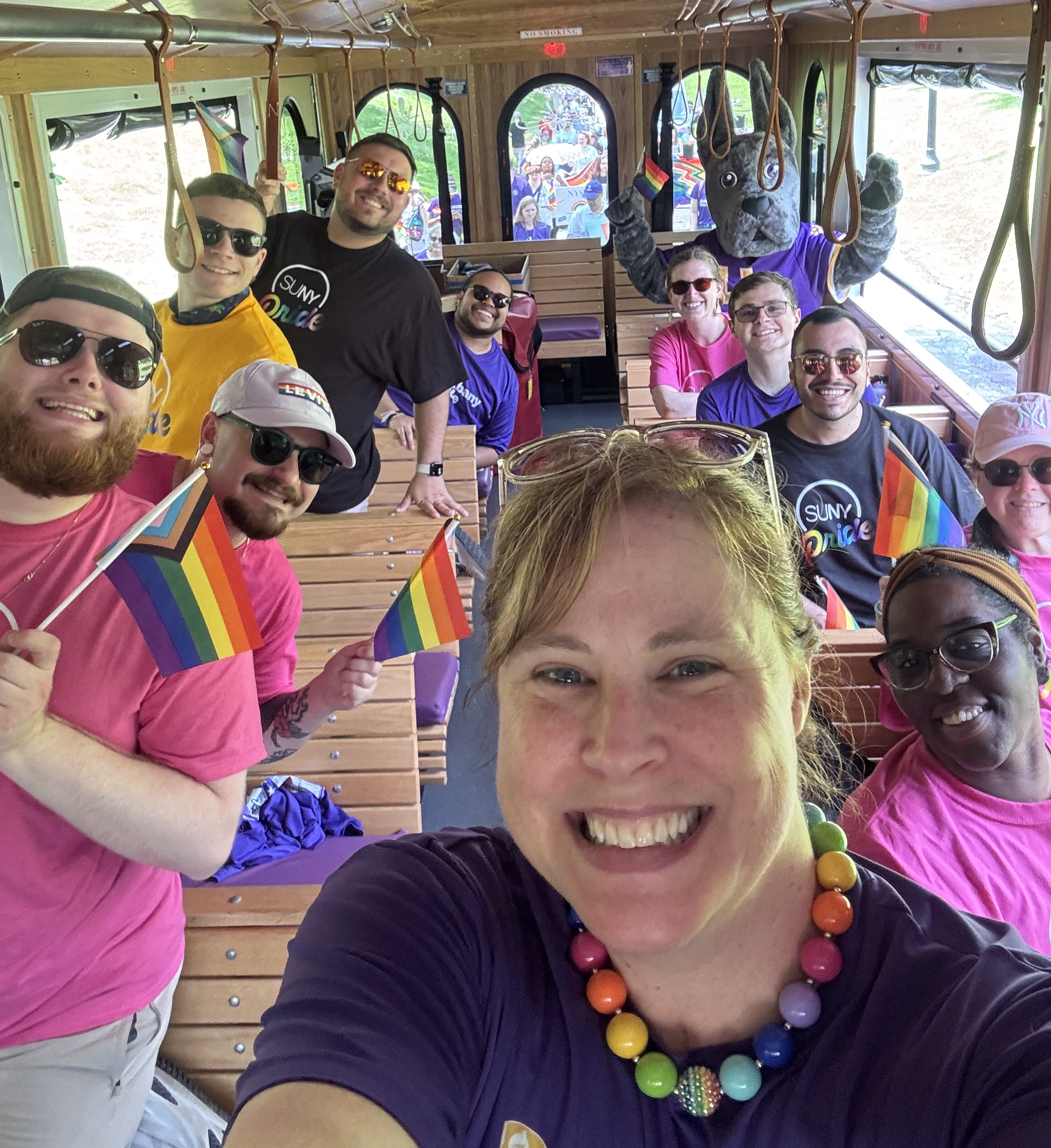 A group of people ride a trolley.