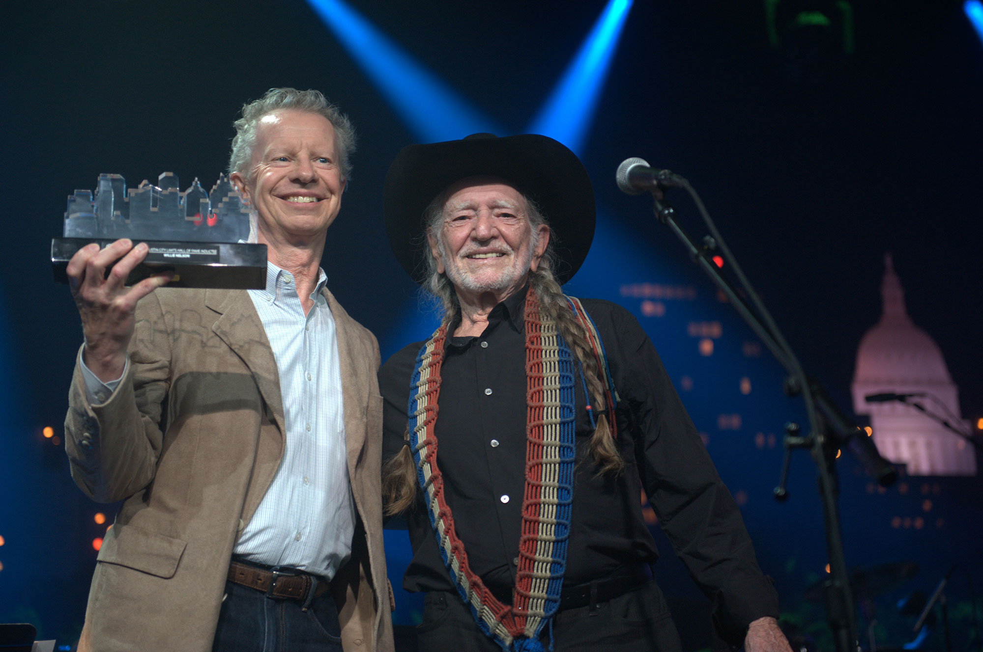 Terry Lickona, a middle-aged white male, poses for a photo with musician Willie Nelson, also a white male.