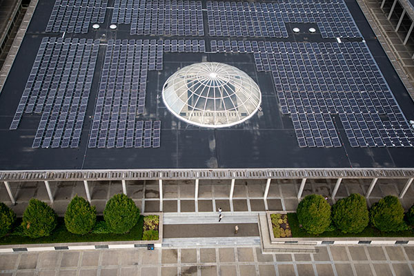 Looking down at solar panels that are on top of the podium roof.