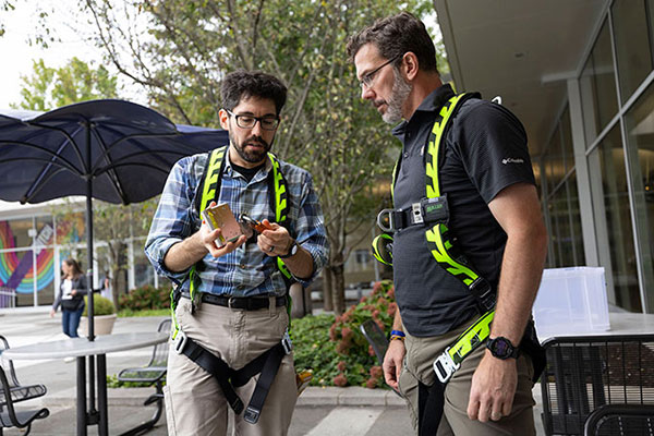 Brian getting a lesson about the harness and safety equipment before climbing to the top of the tower.