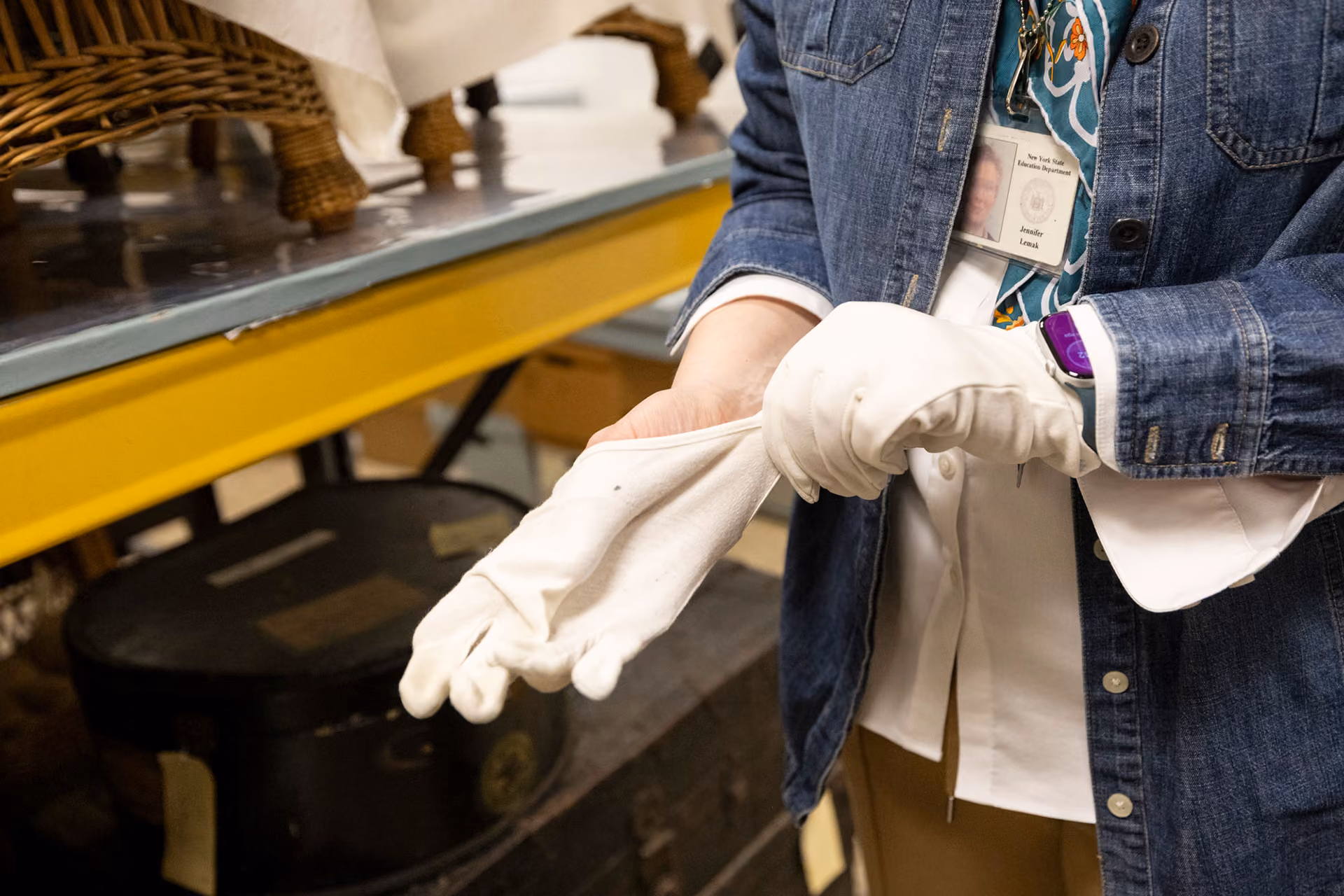 Lemak puts on white gloves.