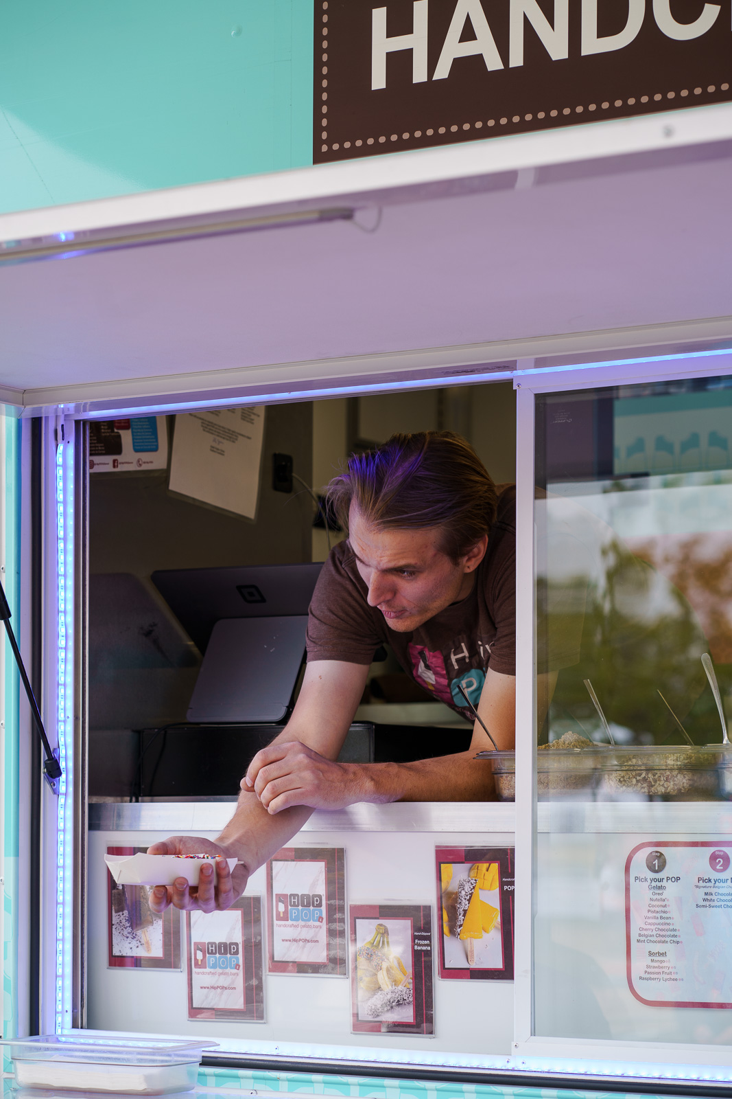 Man handing out ice cream from a food truck