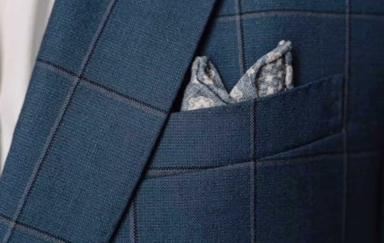 A close up of a person wearing a suit with a bow tie.