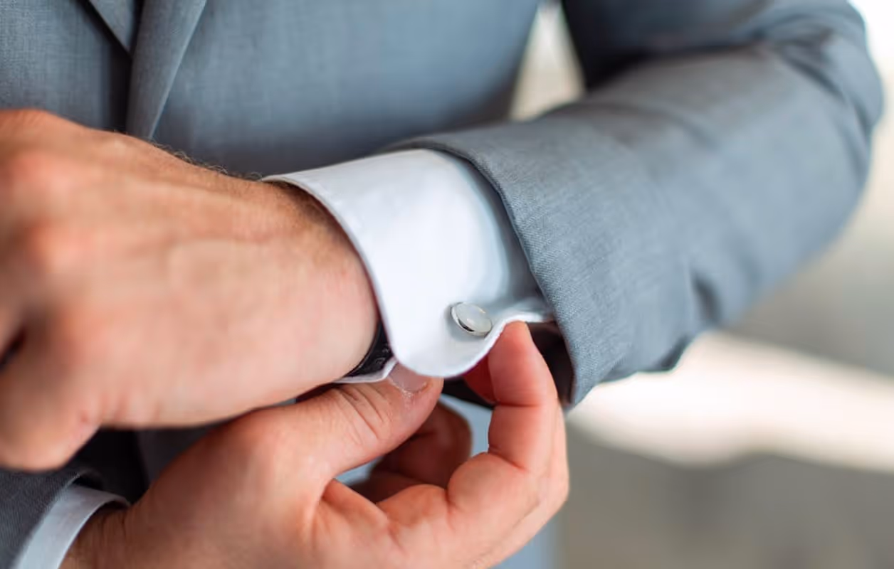 A close up of a person wearing a suit and tie.
