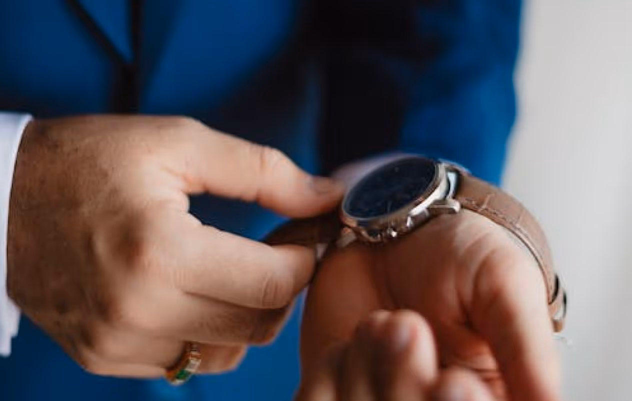 A close up of a person adjusting a watch.