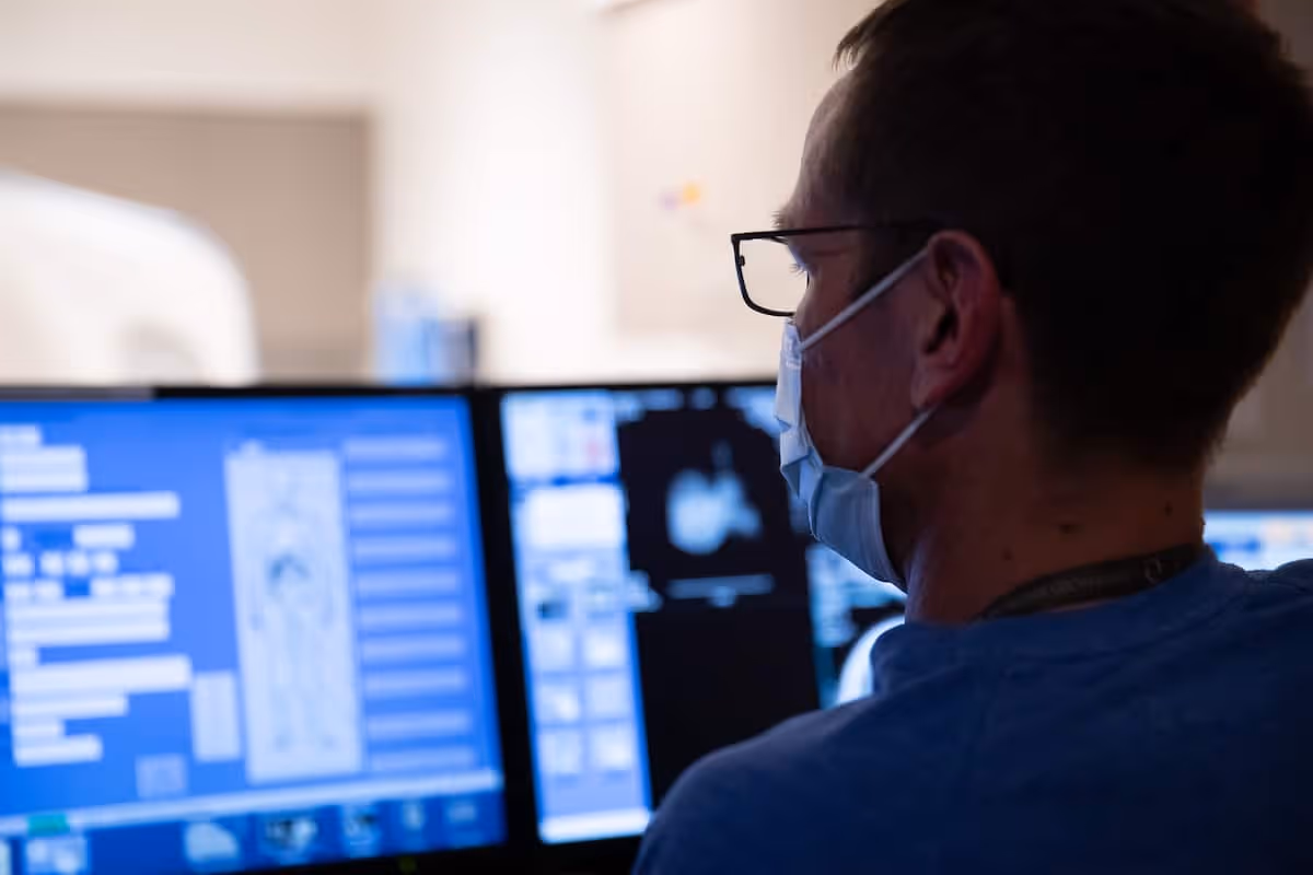 A radiologist reading screens