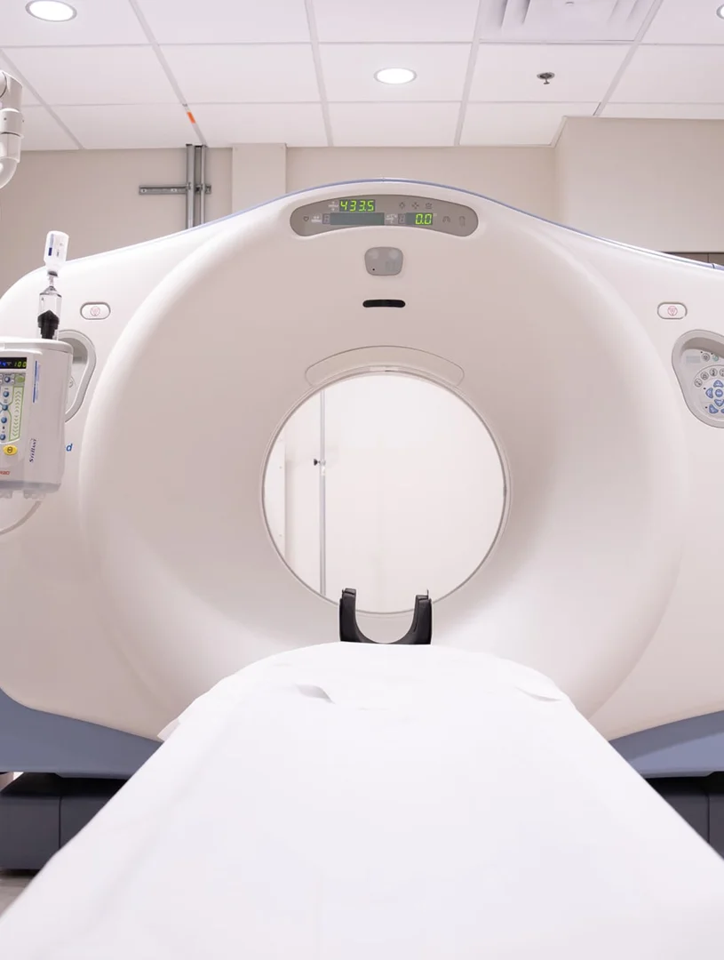 Infographic showing how CT scans create cross-sectional body slices like layers of a loaf of bread, with labels for X-ray