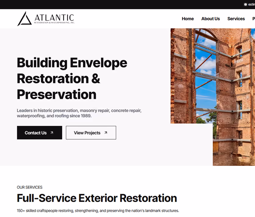 Website homepage for Atlantic Restoration & Waterproofing, featuring a brick building under restoration, bold text about building envelope restoration and full-service exterior restoration.