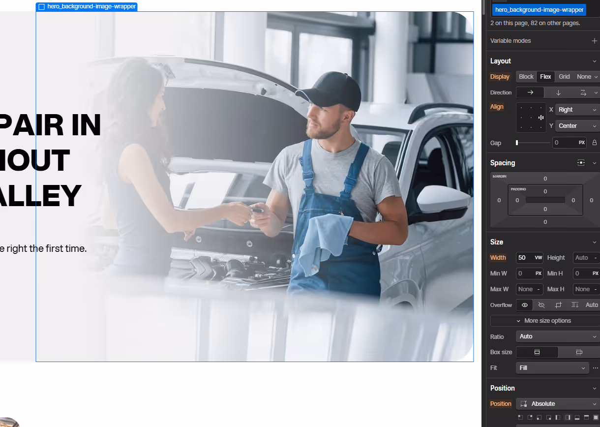 Mechanic in blue overalls handing car keys to a woman near a car with its hood open in a workshop.