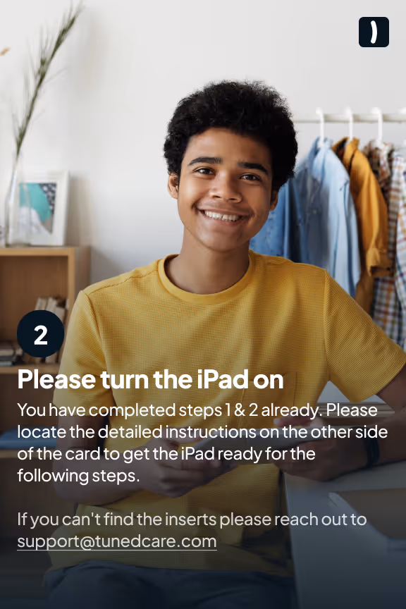 Smiling young man in a yellow shirt holding an iPad with text overlay instructing to turn the iPad on and check detailed steps on the other side of the card.
