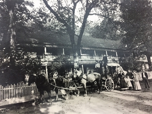 A historical photograph of carrville inn with a horse drawn carriage.