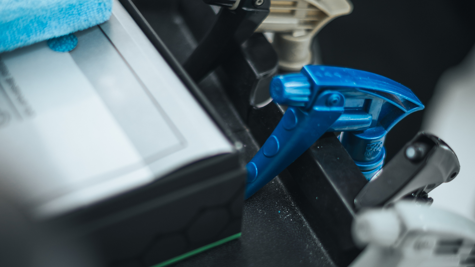 Close up of precision car cleaning Toronto process showing detailing spray and microfiber cloth used during professional car wash Toronto service.