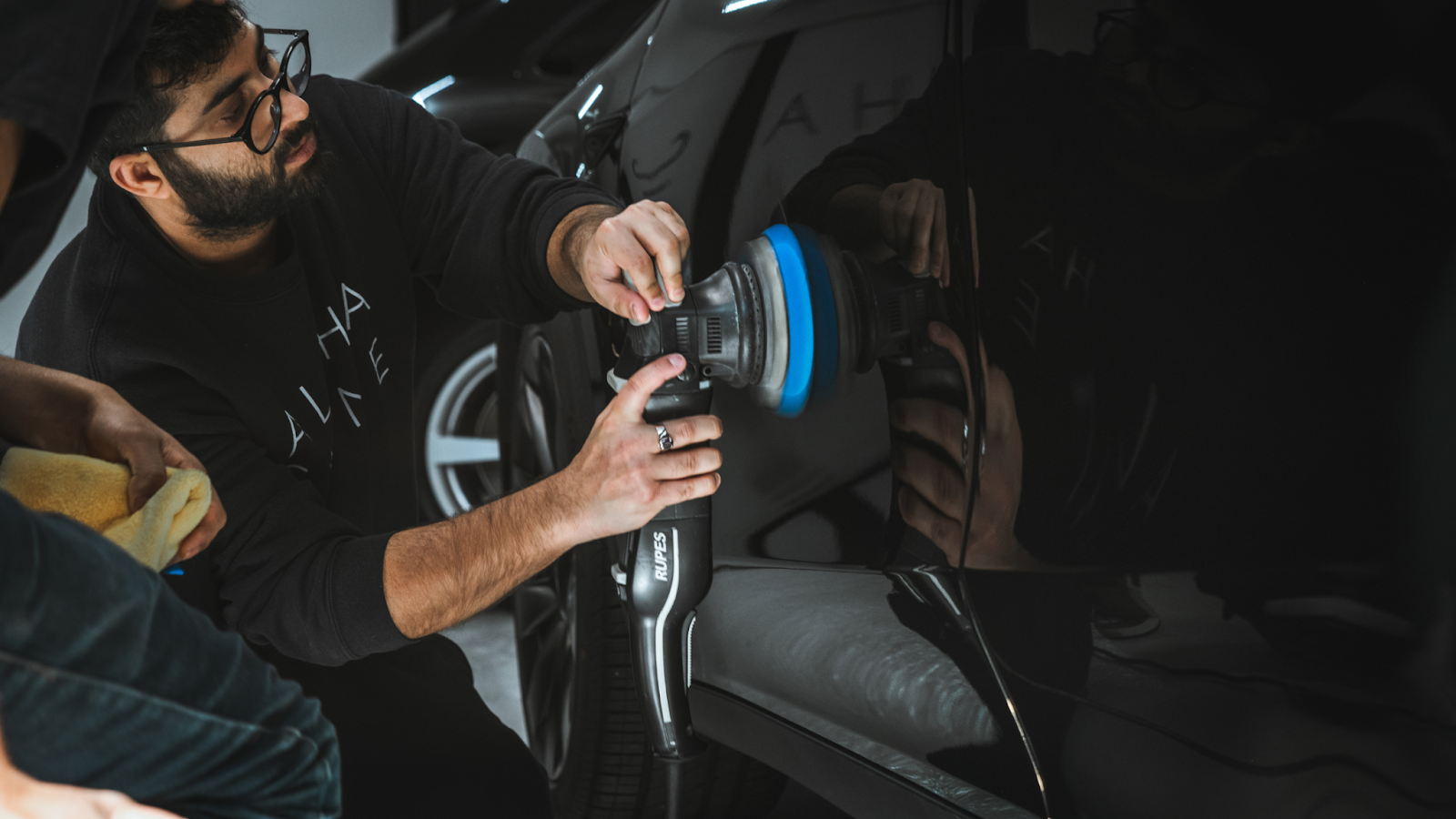 Professional car paint correction process performed by an auto detailing expert, showcasing car detailing paint correction near me with precision polishing to restore paint clarity.