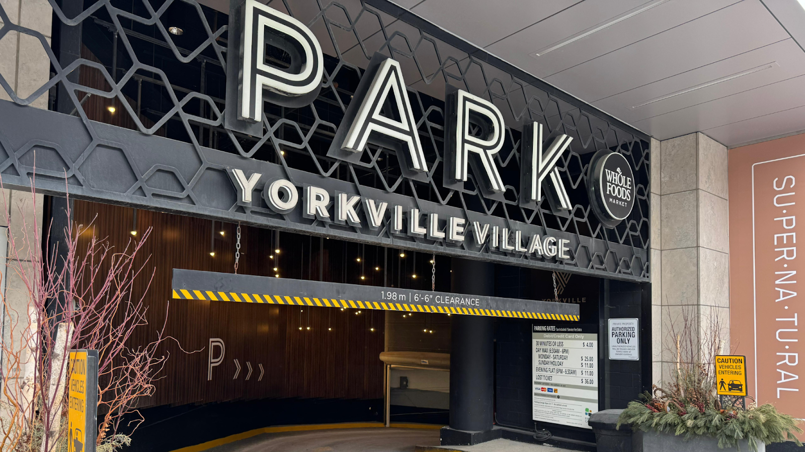 Entrance to Yorkville Village parking with signage near Alphashine Yorkville car detailing location, convenient for Yorkville car wash and interior detailing services.