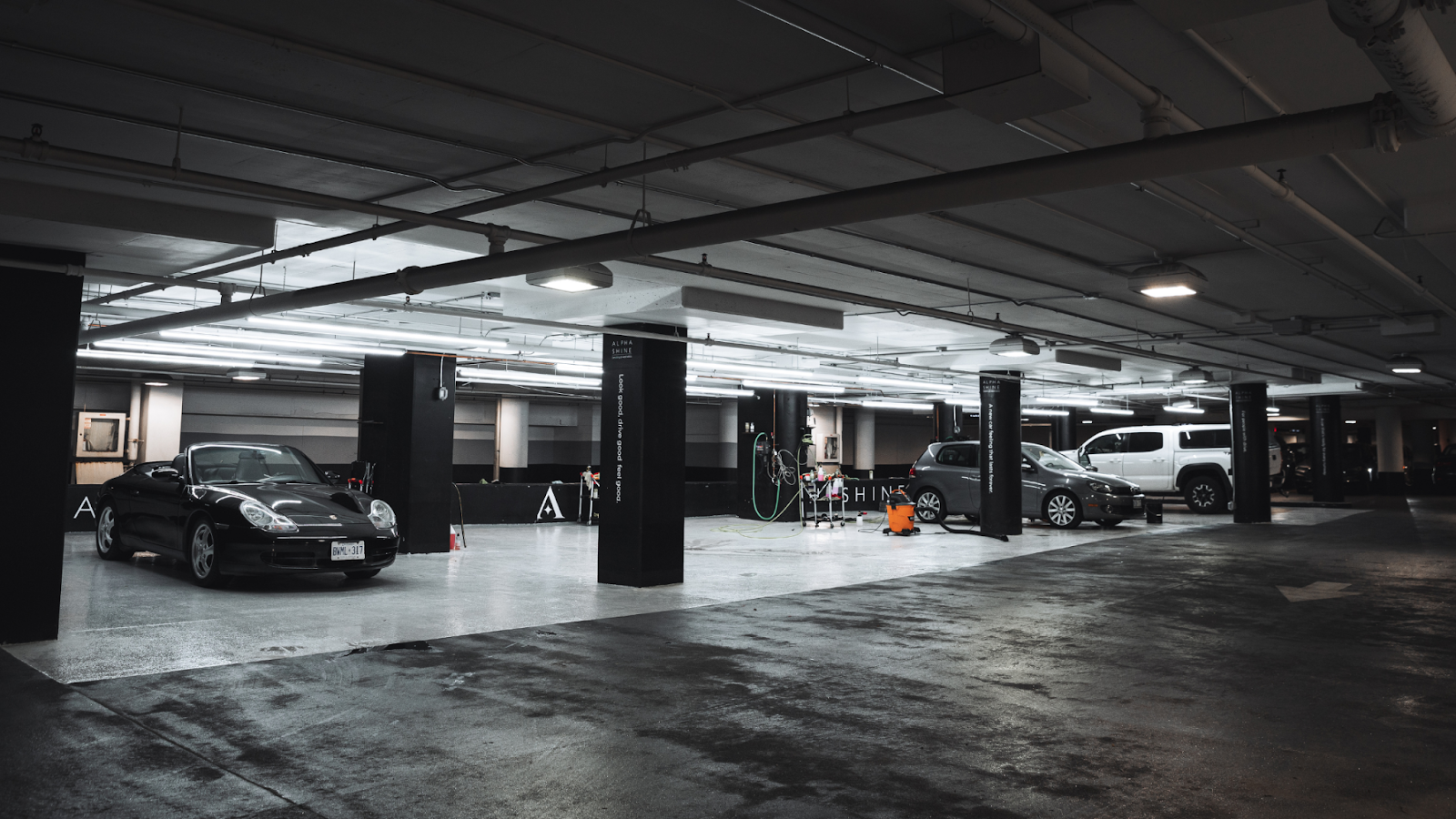Indoor Yorkville car detailing facility with multiple vehicles receiving professional Yorkville car wash and interior detailing services in a clean garage setting.