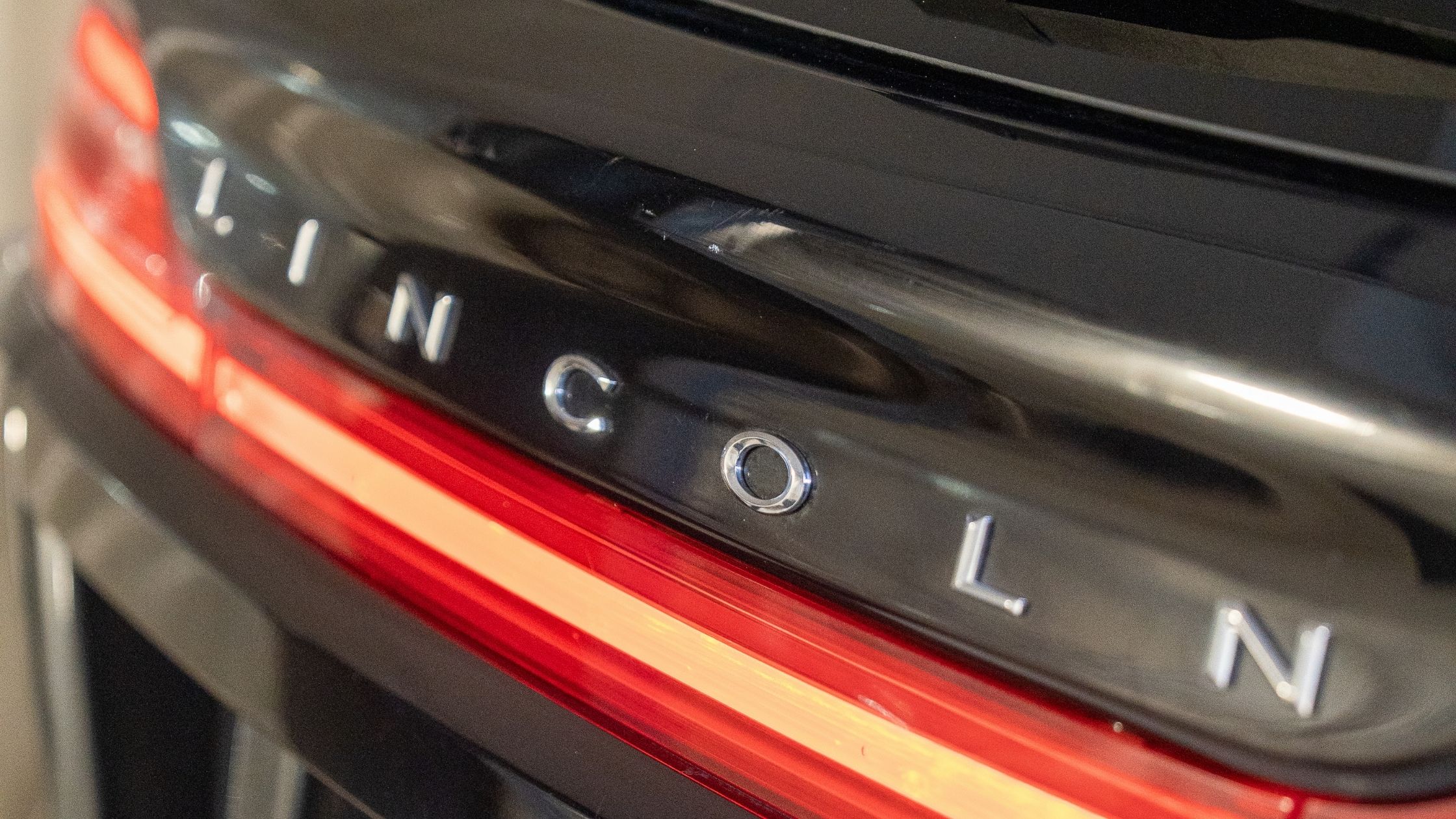 Rear view of a Lincoln SUV with illuminated taillight after professional car detailing service in Toronto, highlighting clean paint and polished exterior.