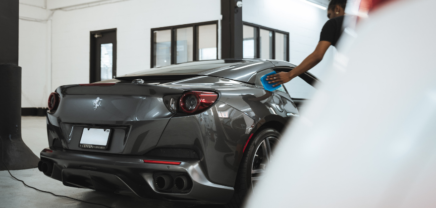 Ferrari receiving professional exterior car wash and paint care by ALPHASHINE car detailing Toronto, representing high end auto detailing near me with expert hands at work.