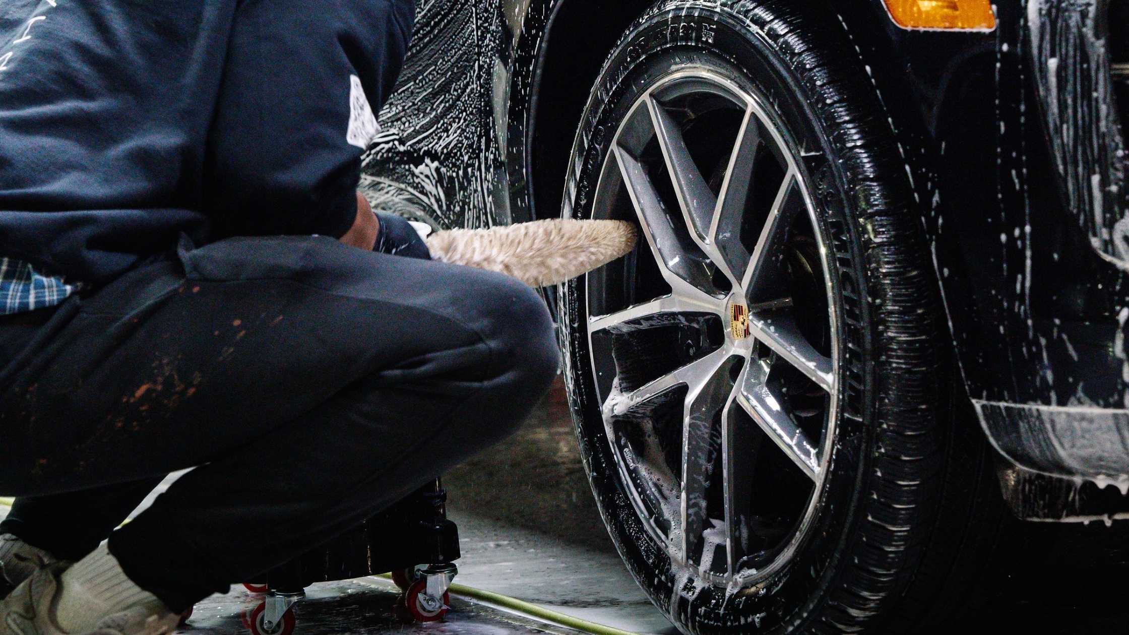 Wheel cleaning in progress with detailing brush and foam at ALPHASHINE Toronto, professional exterior car detailing