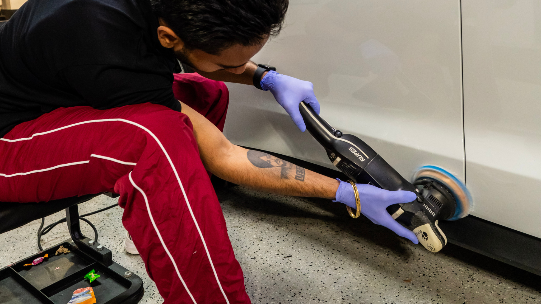 Technician performing paint correction with machine polisher at ALPHASHINE, exterior detailing service in Toronto