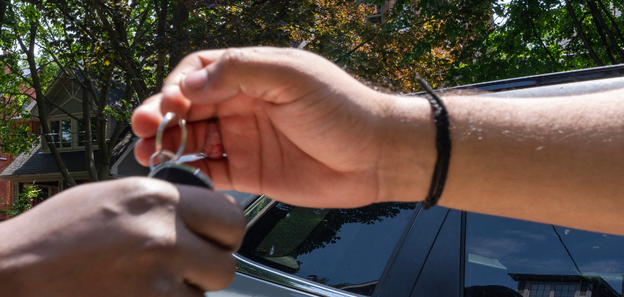 Customer handing over car keys for valet service from ALPHASHINE Car Detailing in CabbageTown, Toronto.