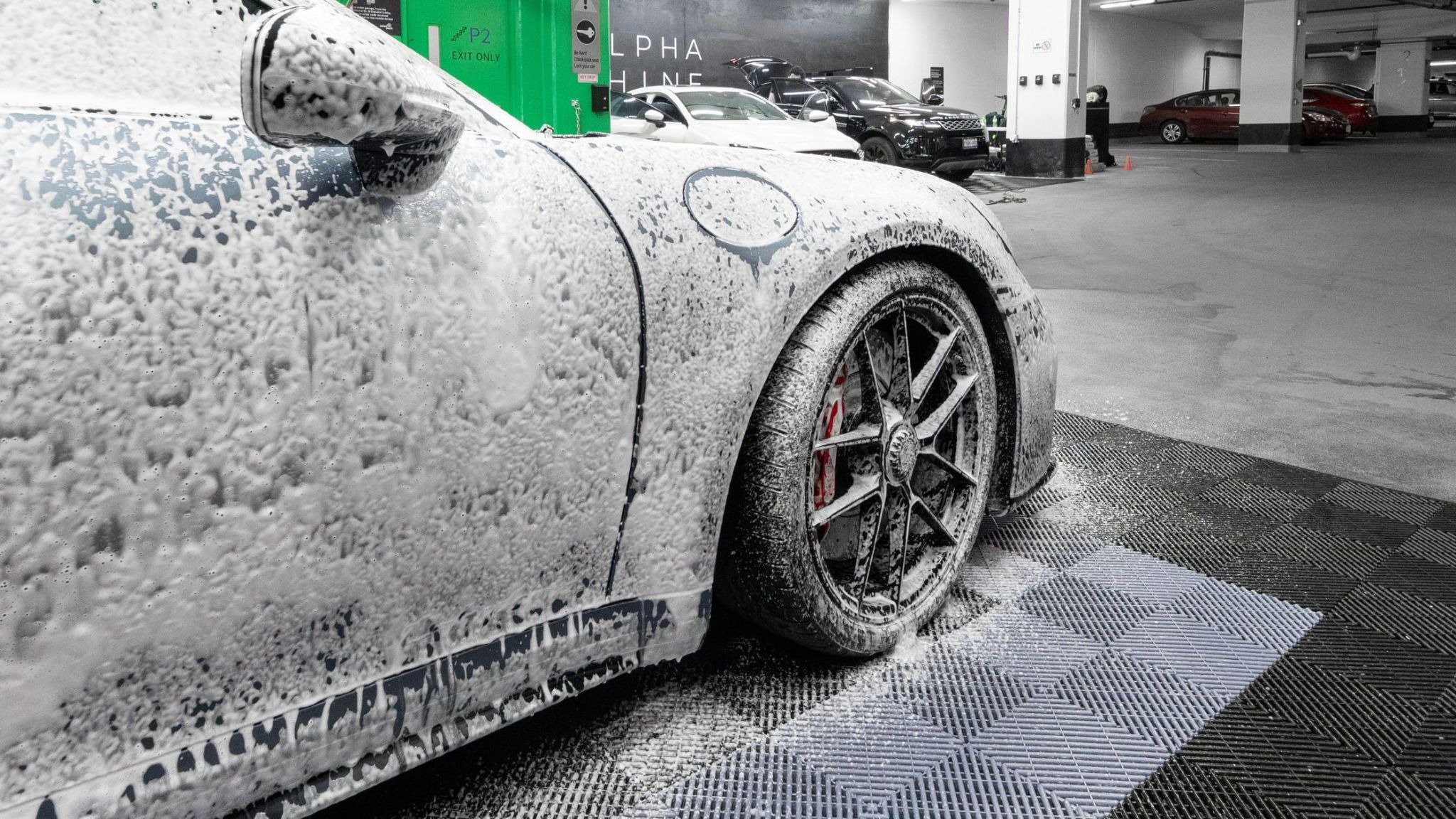 A car cleaning foam covered car being cleaned by ALPHASHINE car detailing Toronto.