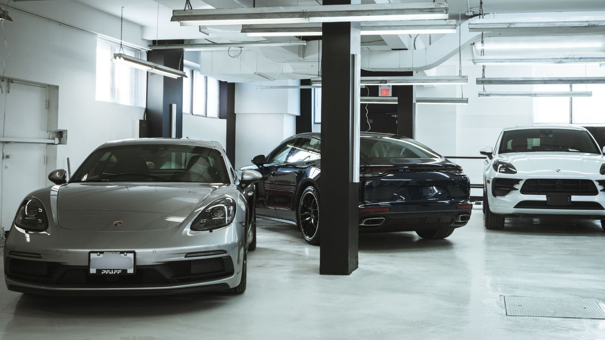 Porsche luxury vehicles inside the ALPHASHINE auto detailing studio in downtown Toronto