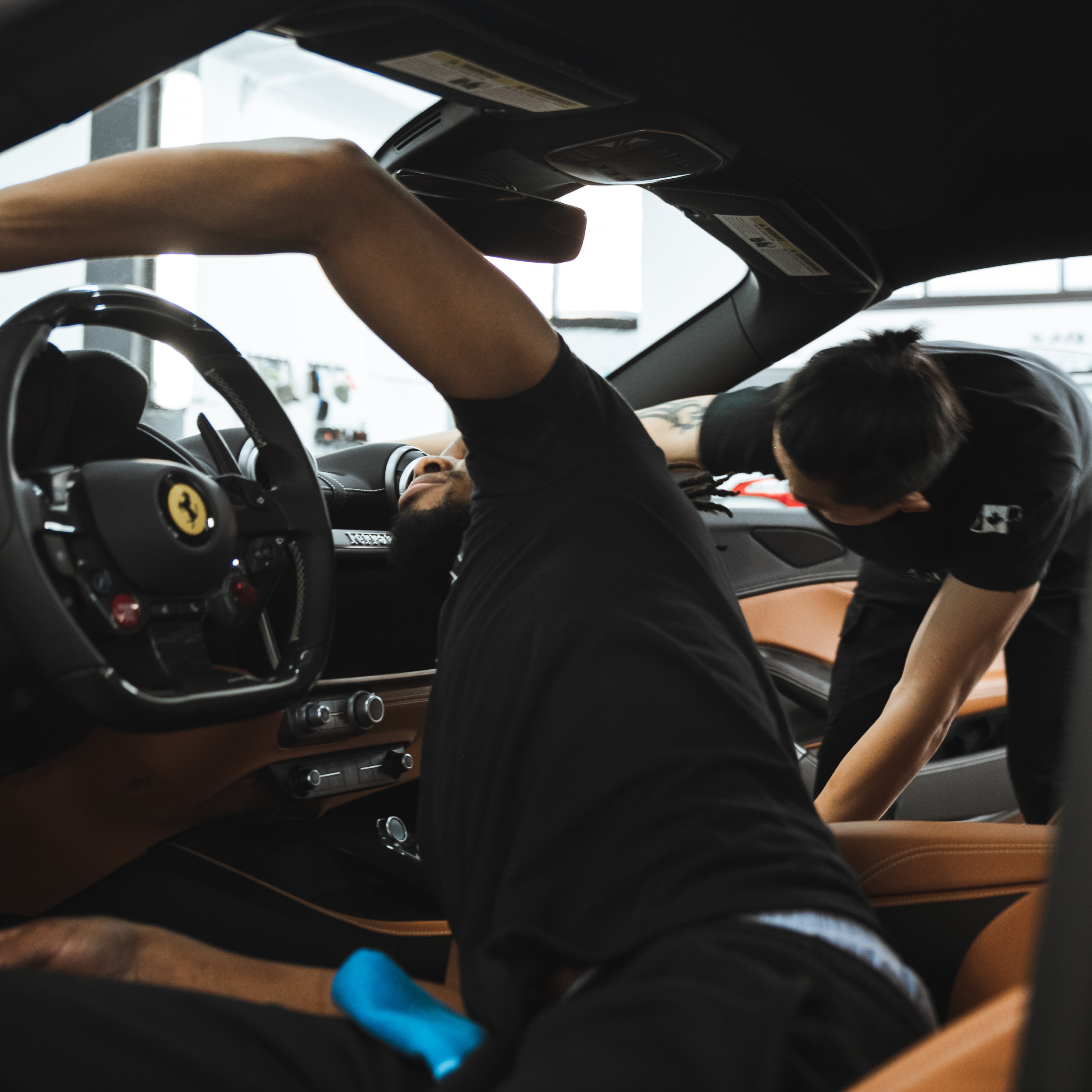 2 alphashine employees cleaning car interior
