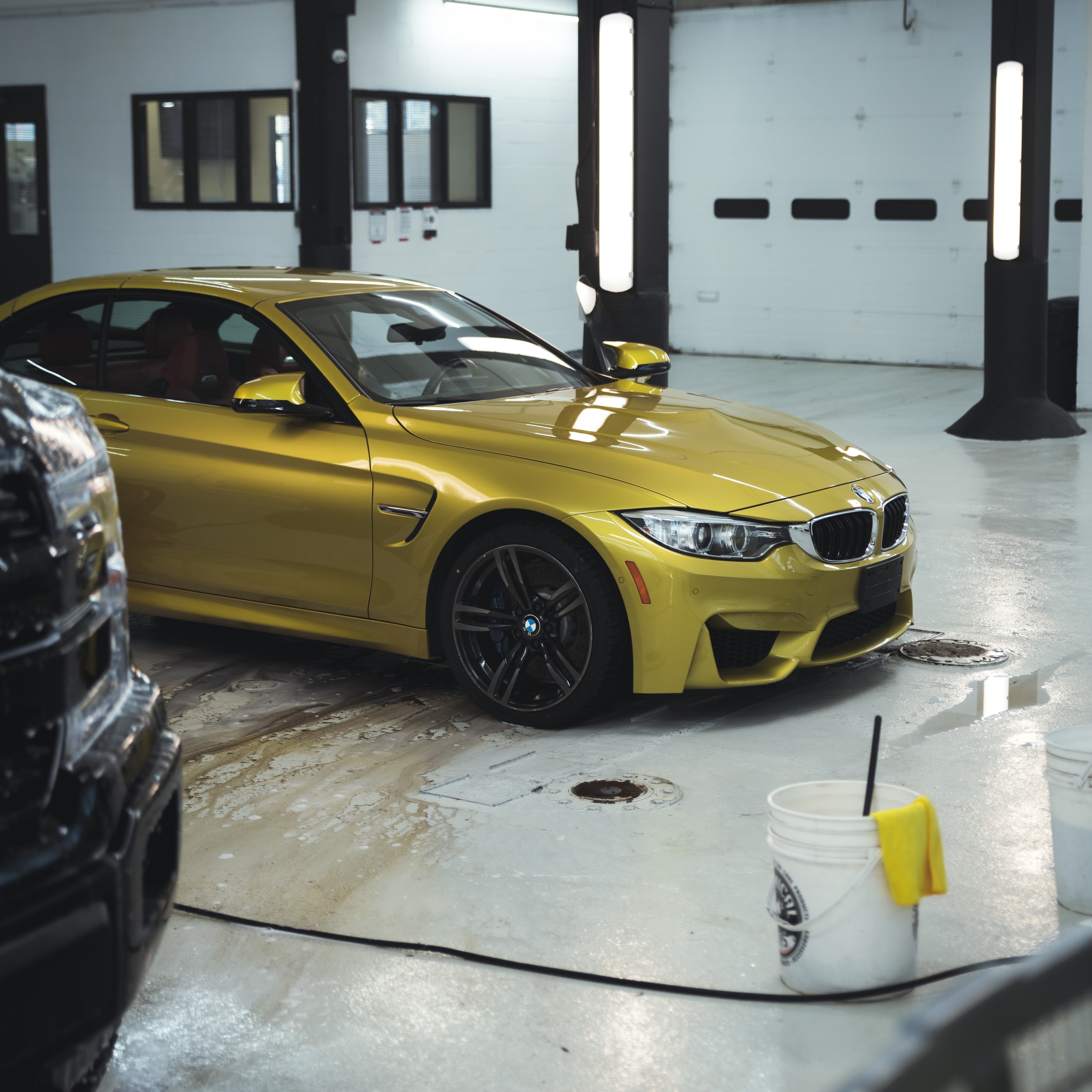 A car cleaned by Alphashine, showing the dirt and grim washed out onto the floor from the engine bay.