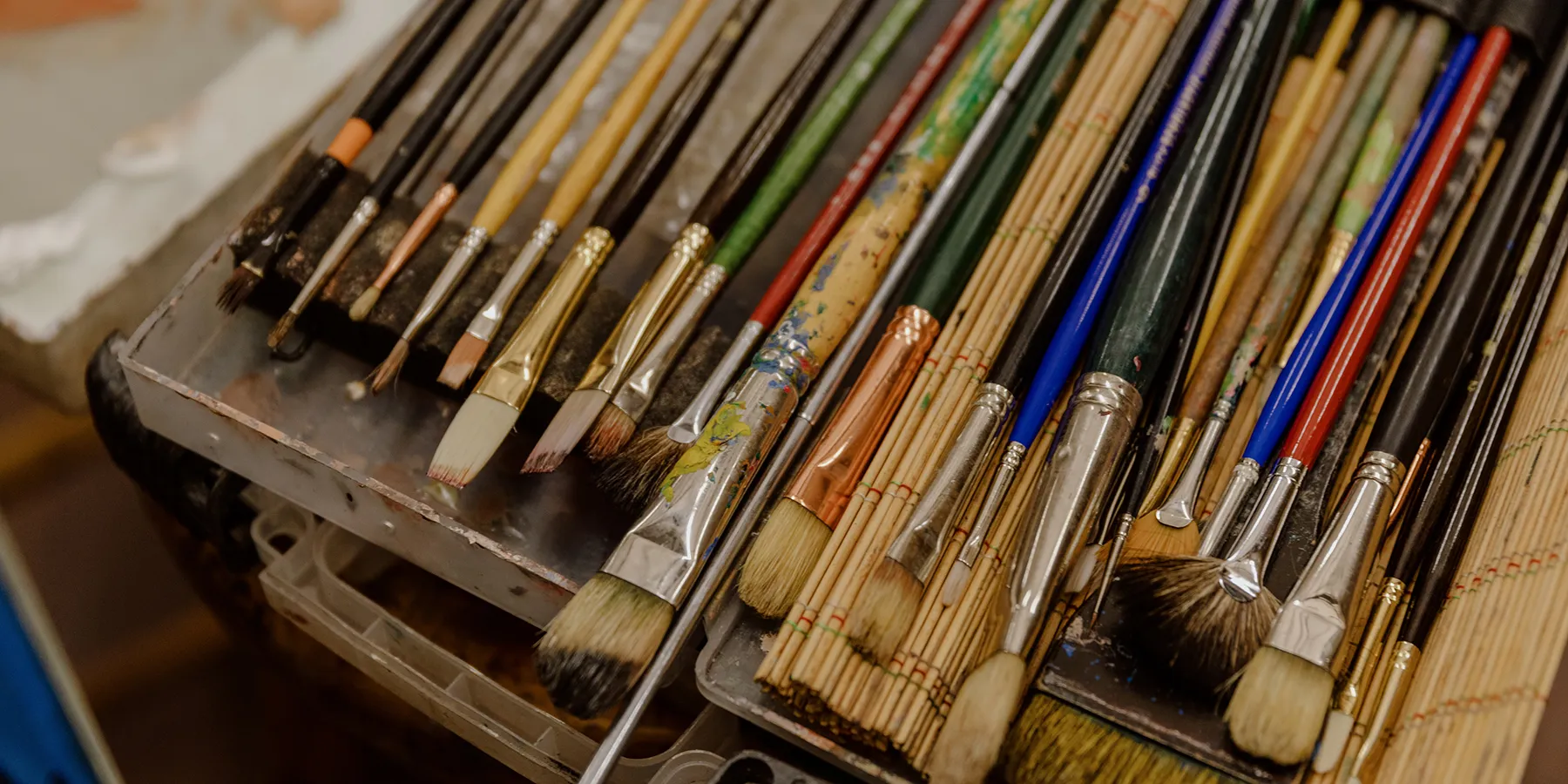 a group of colored pencils