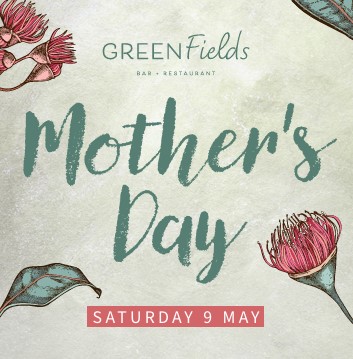 A dining area at a rooftop bar with views of Gold Coast in background