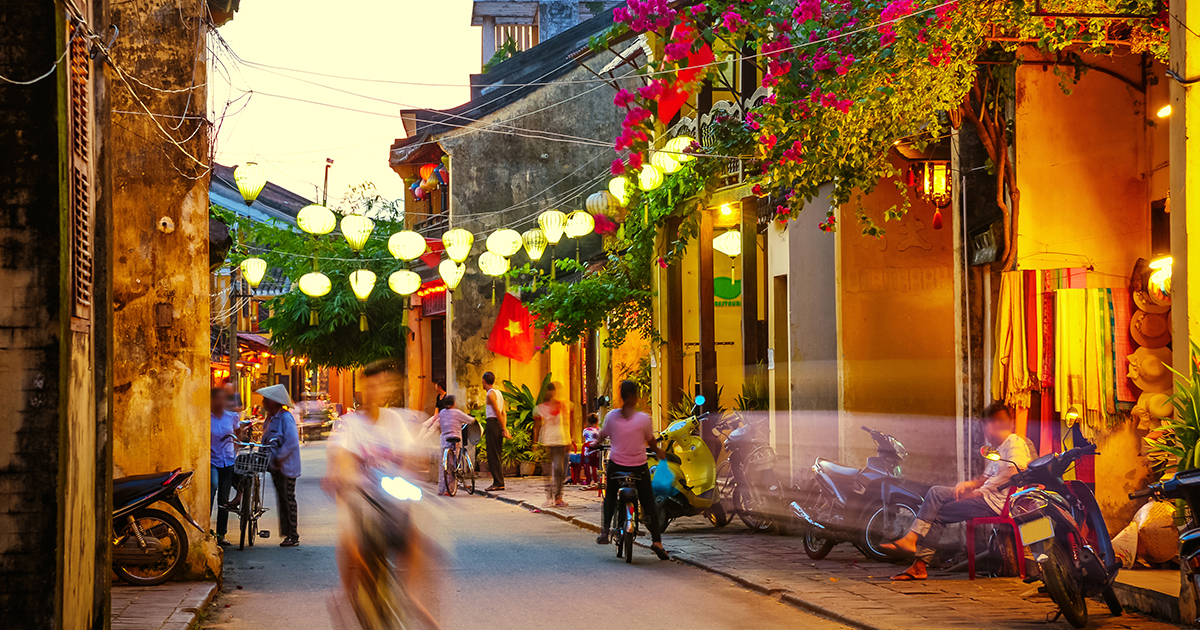 A street in Vietnam at dusk, illuminated by lanterns 