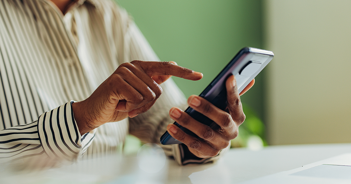 An image of a person holding a smartphone and using it