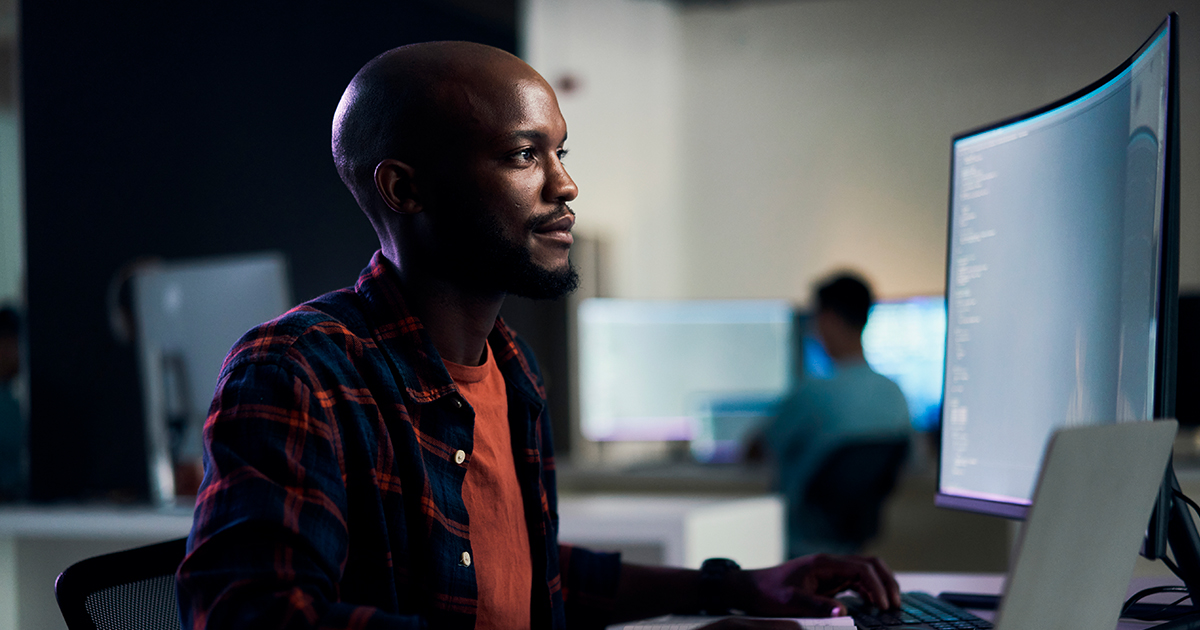 An image of a man using a desktop computer 