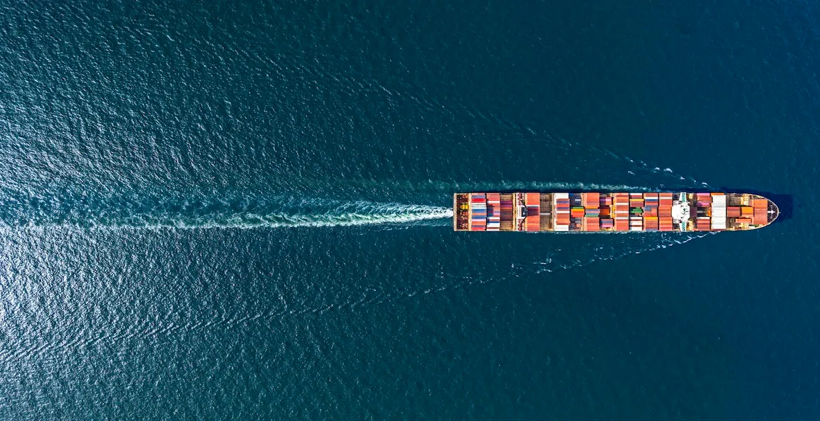 An image of a cargo ship sailing across the ocean