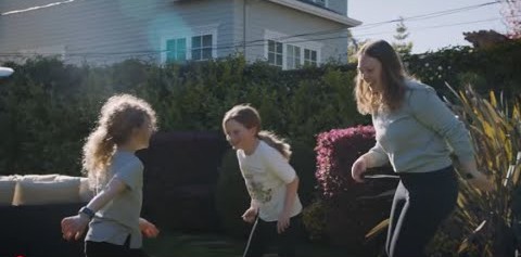 2 kids and 1 woman playing in the garden