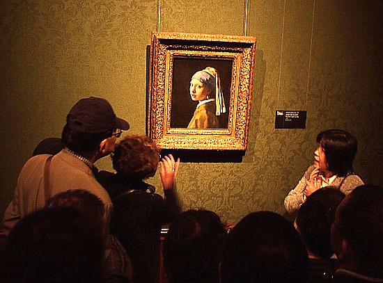 Visitors gathered before Vermeer’s Girl with a Pearl Earring at the Mauritshuis in The Hague, where the painting has resided since 1902.