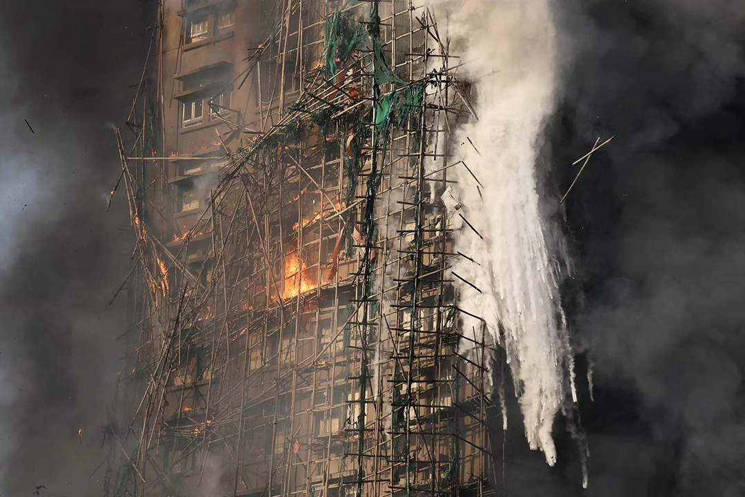 Smoke rises as flames consume the bamboo scaffolding of a building at the Wang Fuk Court housing complex.