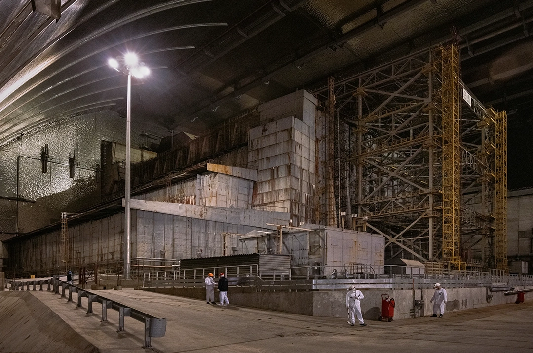 The New Safe Confinement, completed in 2016, encases the ruined reactor and its ageing sarcophagus. © Gerd Ludwig, 2023